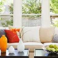 Three sets of windows with a sofa in front
