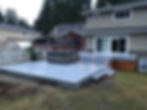 Image of a residential backyard with a gray composite deck