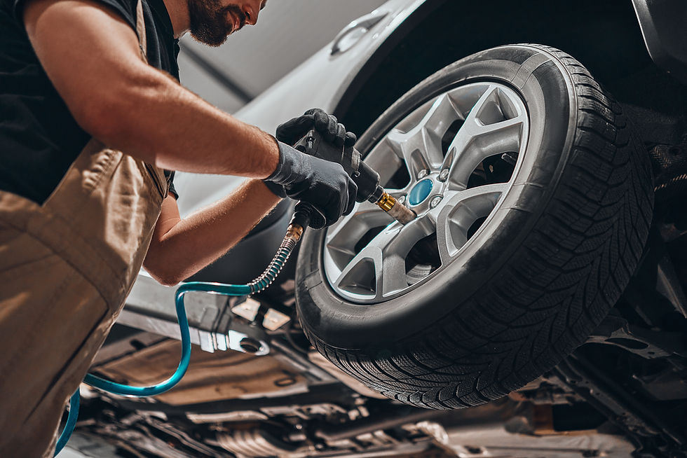 Auto mechanic changing car wheel