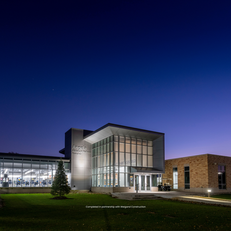 Modern medical facility exterior illuminated at dusk