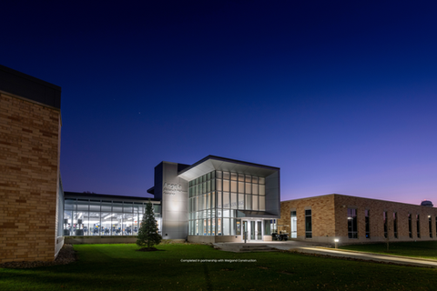 Modern medical facility exterior illuminated at dusk