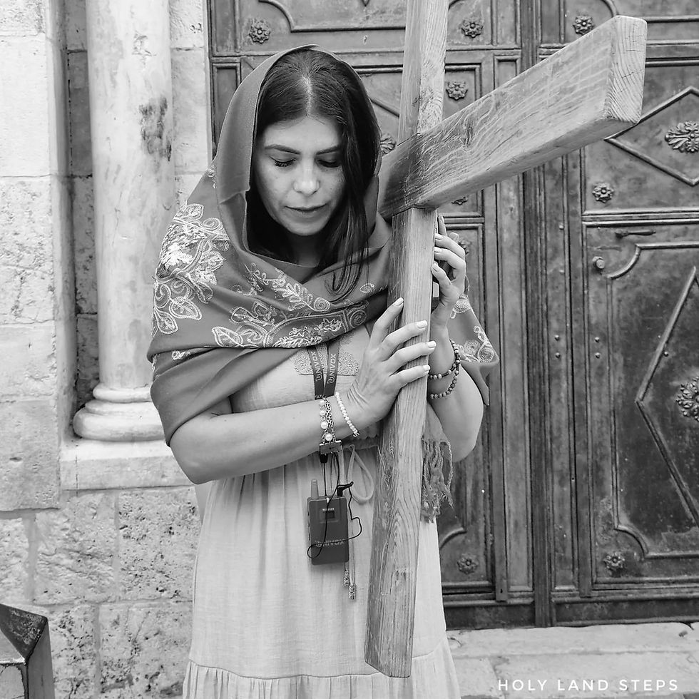 A pilgrim carrying a wooden cross during a procession on the Via Dolorosa