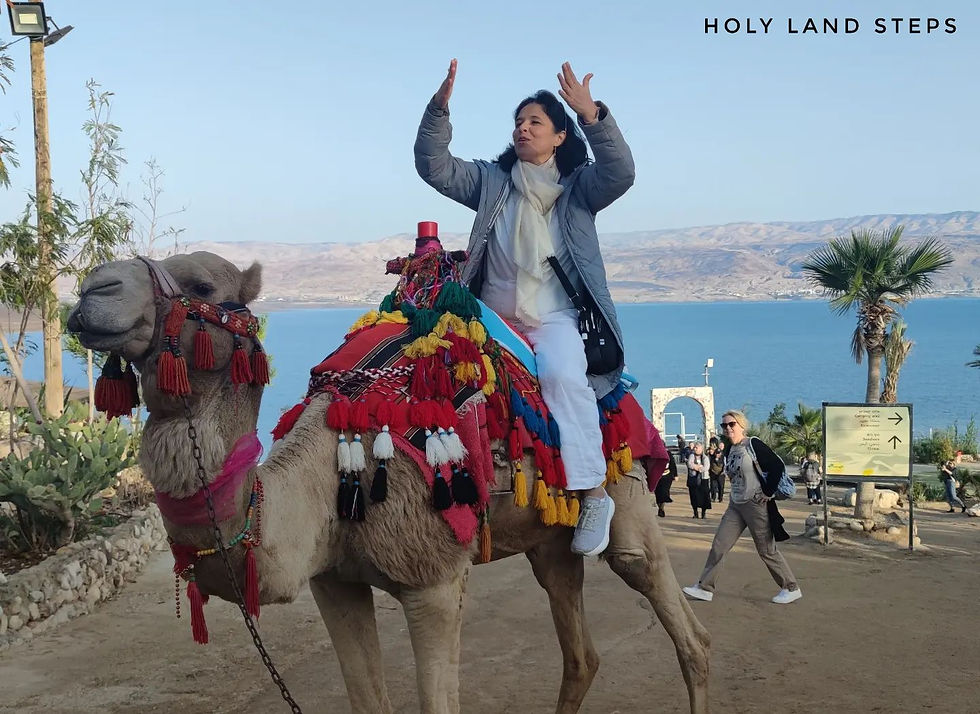 A tourist riding a camel by the Dead Sea.