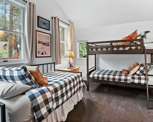 Family-friendly bedroom at Yaya’s by the Lake with daybed/trundle and twin bunk beds in cozy black-and-white buffalo plaid