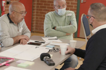 Older adults discussing digital inclusion at a workshop