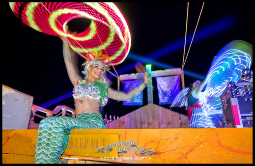 Mermaid with Green tail sitting with LED hoop in hand above her head