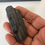 Thumbnail: a hand holding a black rock