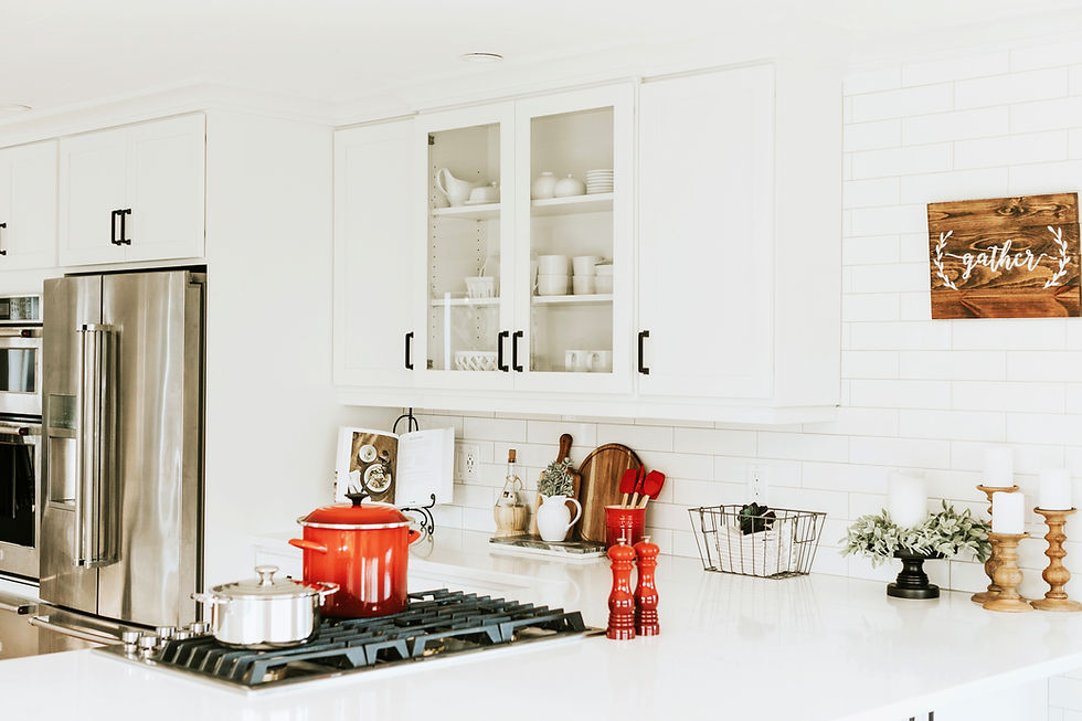 Modern White Kitchen with red pots and a gas stove
