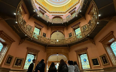 Students and board members looking up at the NJ state capitol dome.