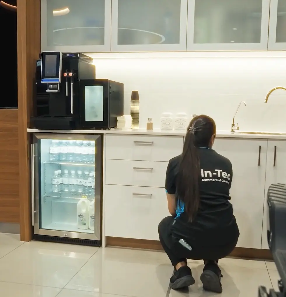 Cleaner wiping down kitchen cabinets