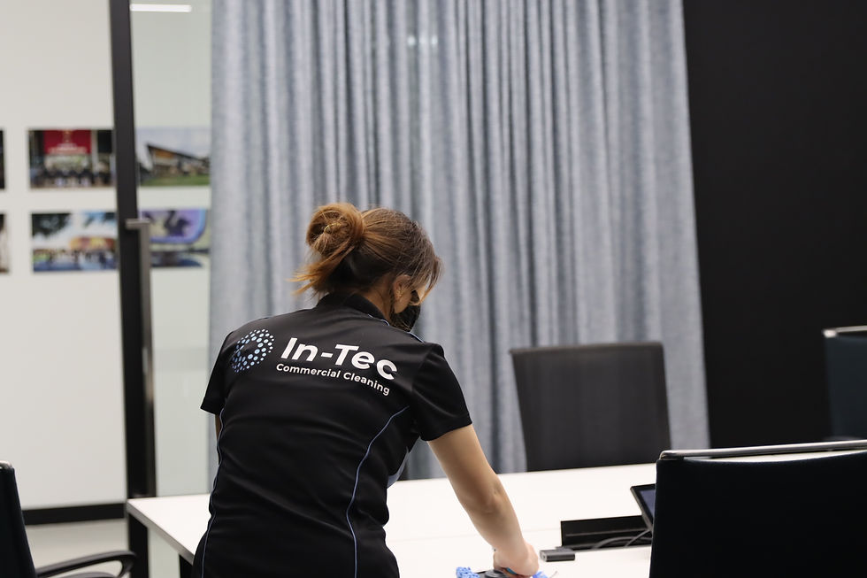 In-Tec cleaner wiping down a desk