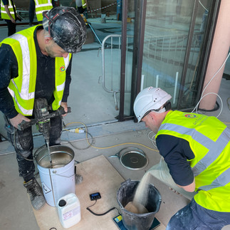 2 men mixing resin and aggregate 