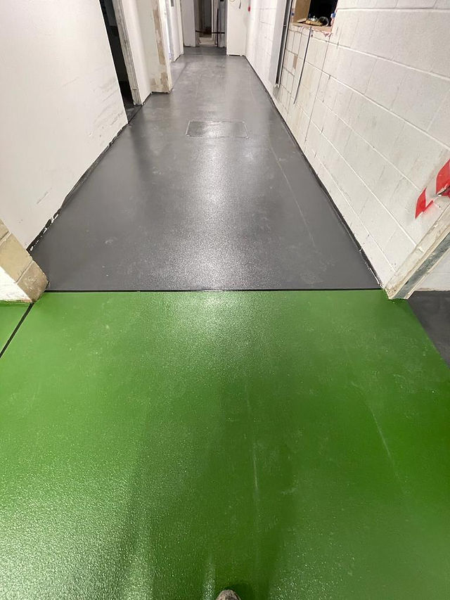 Green and grey resin floor meet.
