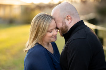 Couple touching foreheads during a romantic sunset photography session
