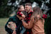 Two parents cuddling their three children during a family Christmas card photography session at Bernheim Forest in Clermont, Kentucky