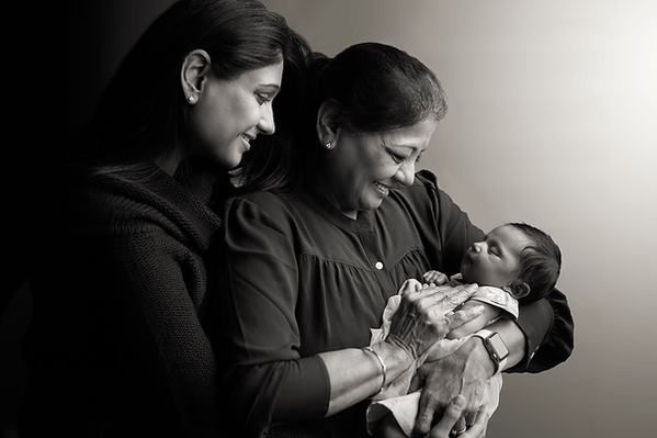 mother and grandmother holding newborn baby black and white family portrait