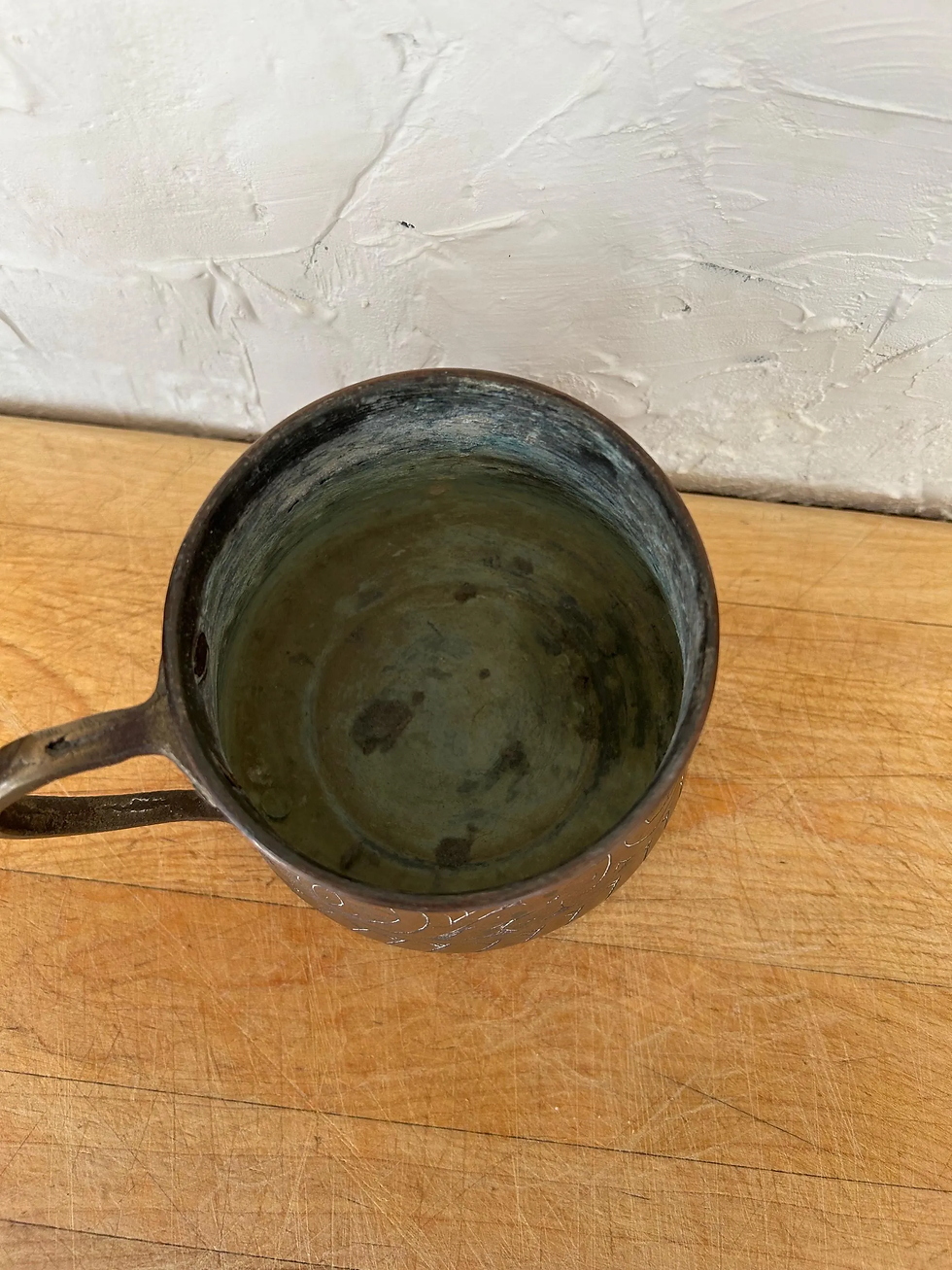 Thumbnail: Top view of a vintage copper mug with etched design