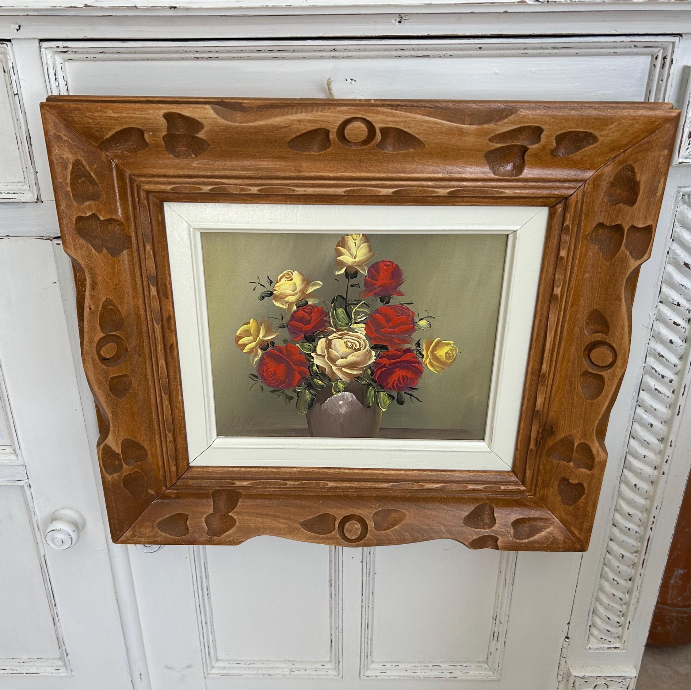 Vintage floral oil painting of roses in wood frame.