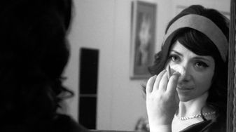 Another still from the Music Vidoe for 1950s Housewife Emily Is putting makeup on in a mirror