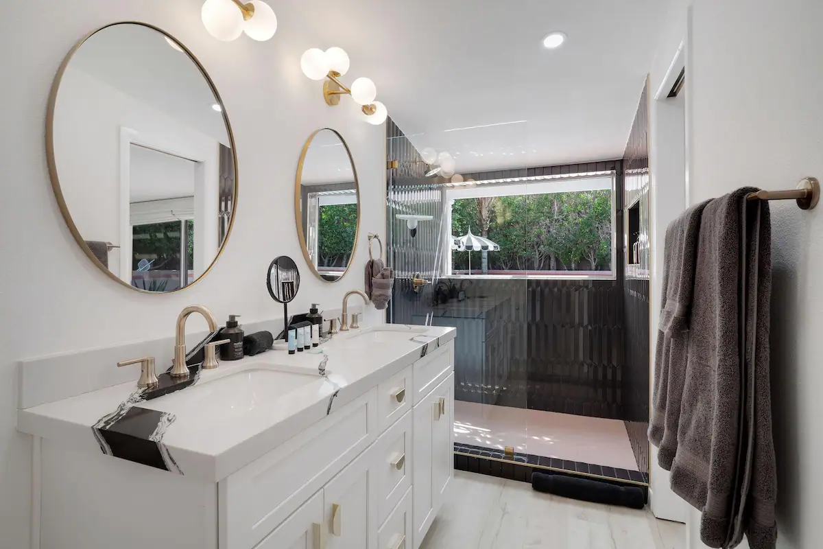 bathroom in palm desert vacation rental with double vanity and modern black tile shower