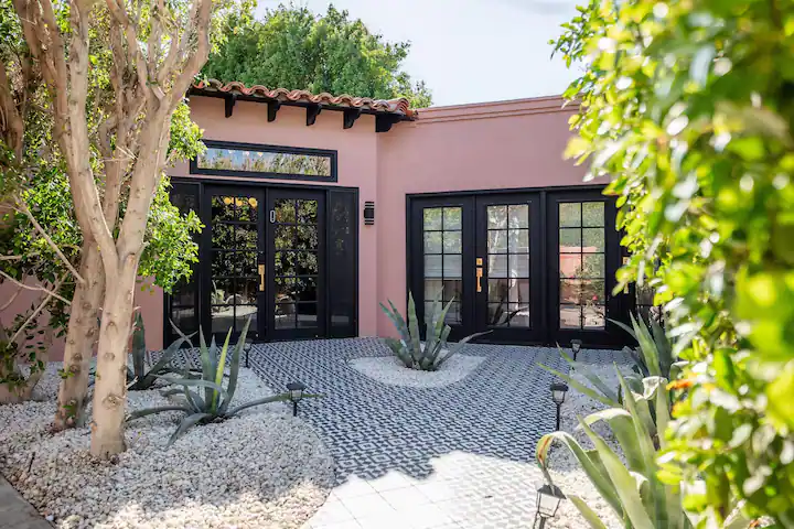 front courtyard at modern palm desert vacation rental with geometric tile and large windowed doors