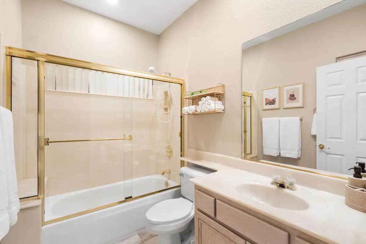 bathroom in Rancho Mirage vacation rental with shower and tub combination and large vanity with mirror