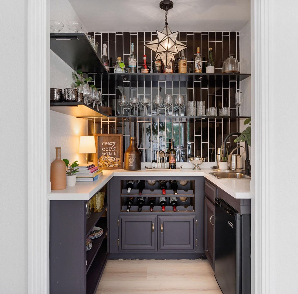 bar nook in Coachella Valley rental home with black subway tile, bar sink, and extensive wine collection 