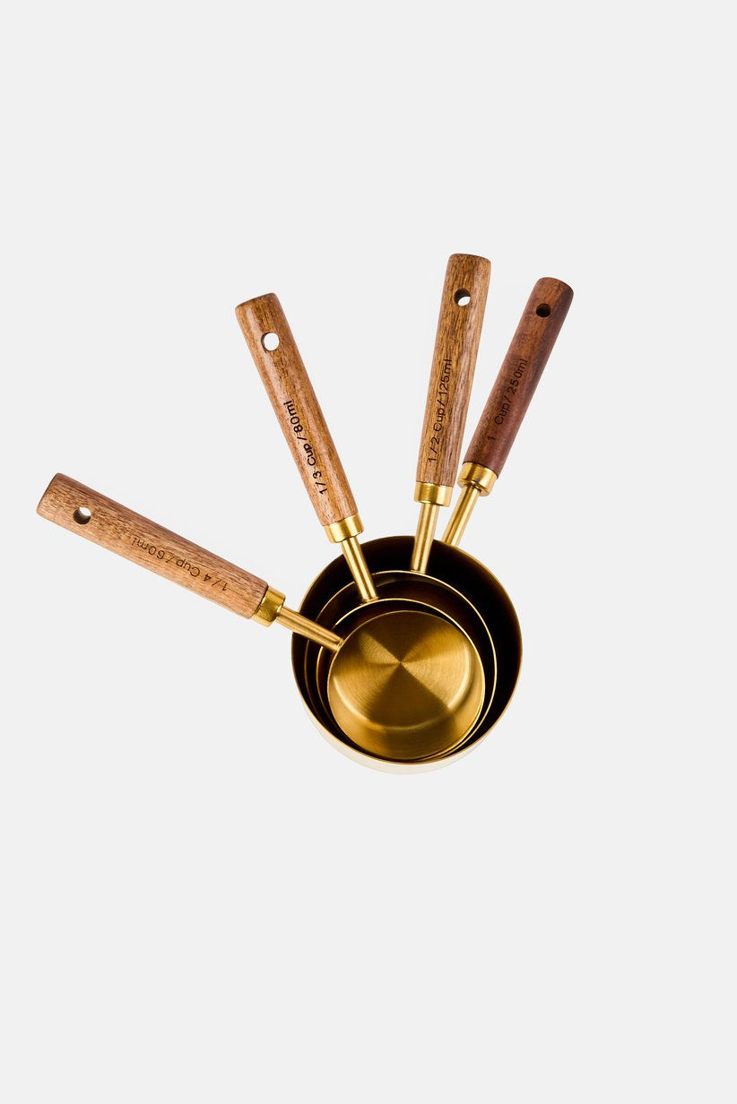 Thumbnail: Bebe Home
A Set Of Measuring Cups With Wooden Handle, Gold
