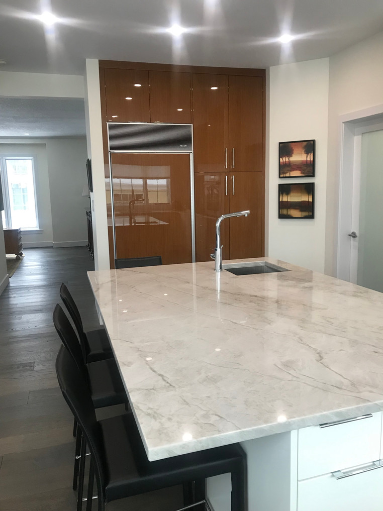 Modern kitchen. Quartzite countertops. High glass cherry veneer cabinets.
