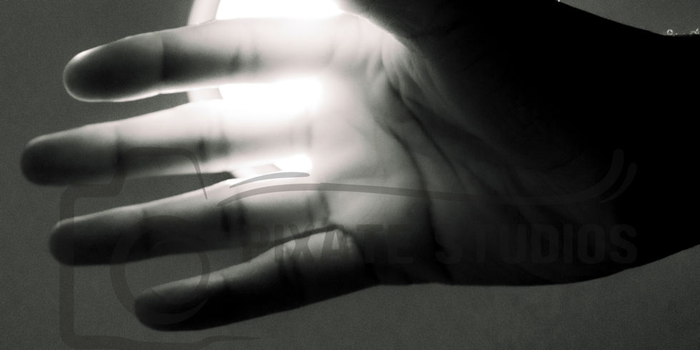 Shot of a hand's palm held up against a light source_