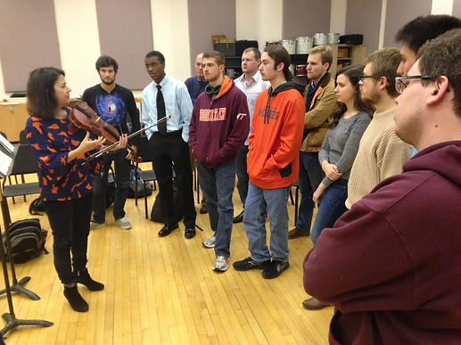 Sarah Plum talking to a large group of students standing around her