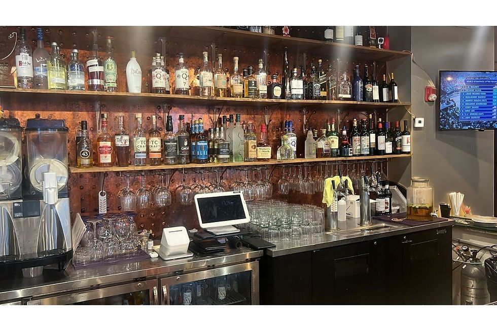 Full-service bar inside a turnkey restaurant for sale in Decatur, GA — featuring premium liquor display, glassware, draft taps, and POS setup. Presented by Jimmy Carey Commercial Real Estate, Atlanta’s Premier Restaurant Broker.
