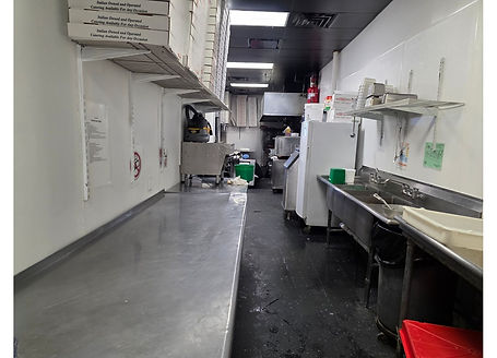 Commercial restaurant prep and dishwashing area with stainless steel worktables, triple compartment sink, storage shelving, and back-of-house kitchen layout inside a turnkey pizzeria. Image by Jimmy Carey Commercial Real Estate, Atlanta Restaurant Business Broker.