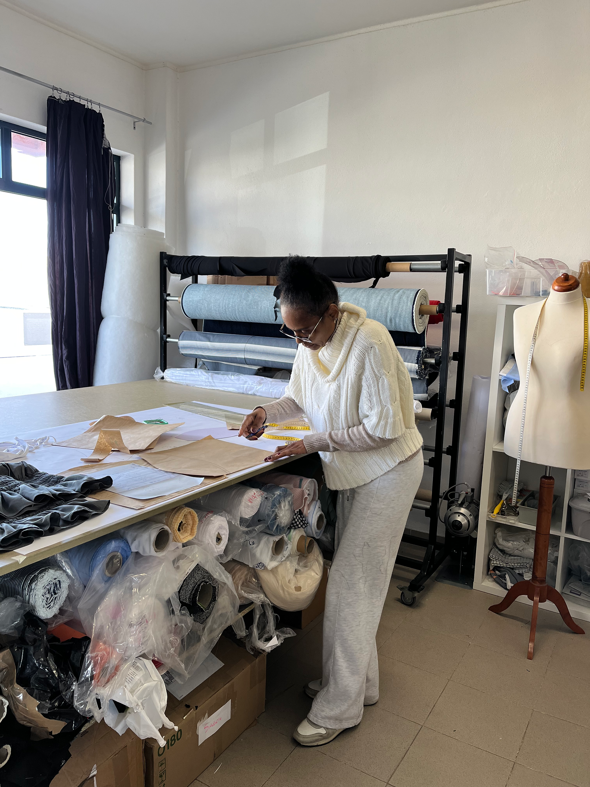 A skilled pattern maker at the atelier, creating upcycled corsets. A scene at Aurore Being's manufacturer, Ponte de Ponto.