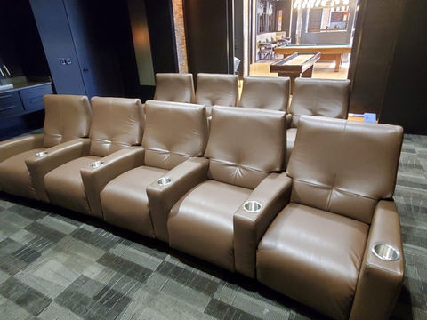 Row of brown leather home theater recliners with cup holders, reupholstered by Mill End Shops.