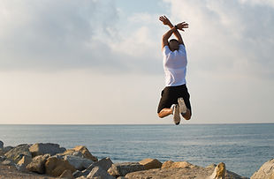 A man jumping for joy because he is recovering from trauma with EMDR.