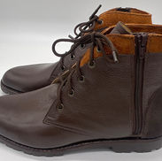 Brown leather custom boots with side zippers and laces.