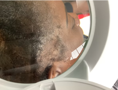 Client receiving holistic scalp treatment at The GuudSeed Company salon in Riverside, CA for natural hair restoration