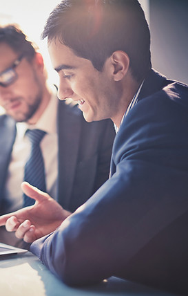 Two men are reviewing a document.