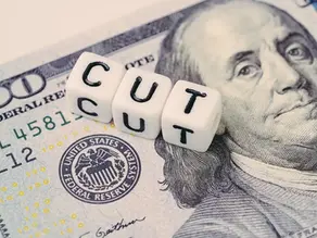 Cubes with the word cut over a 100 dollar bill