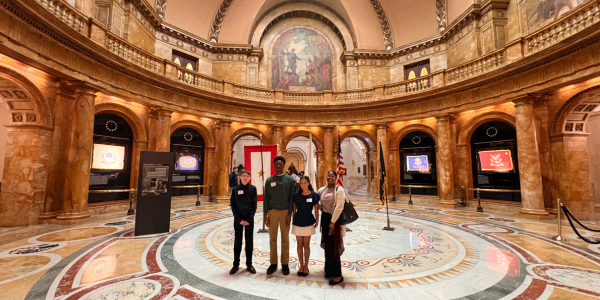 Four teens standing inside the rotunda room of the Massachusetts State House