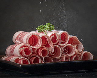 Raw meat prepared for cooking in-table at a Korean Barbecue restaurant.jpg