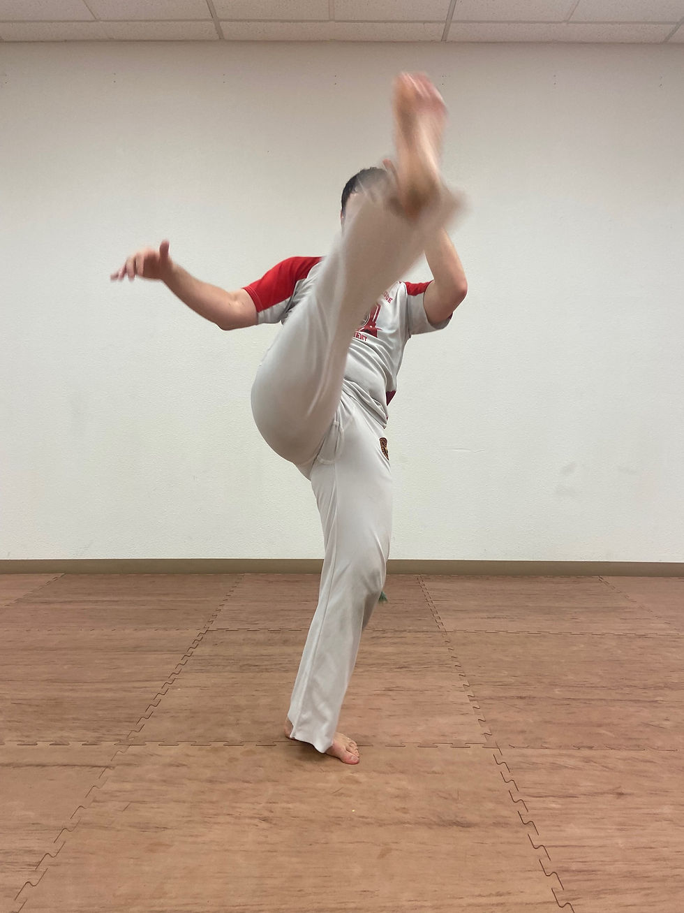 Capoeira student doing the Queixada kick.
