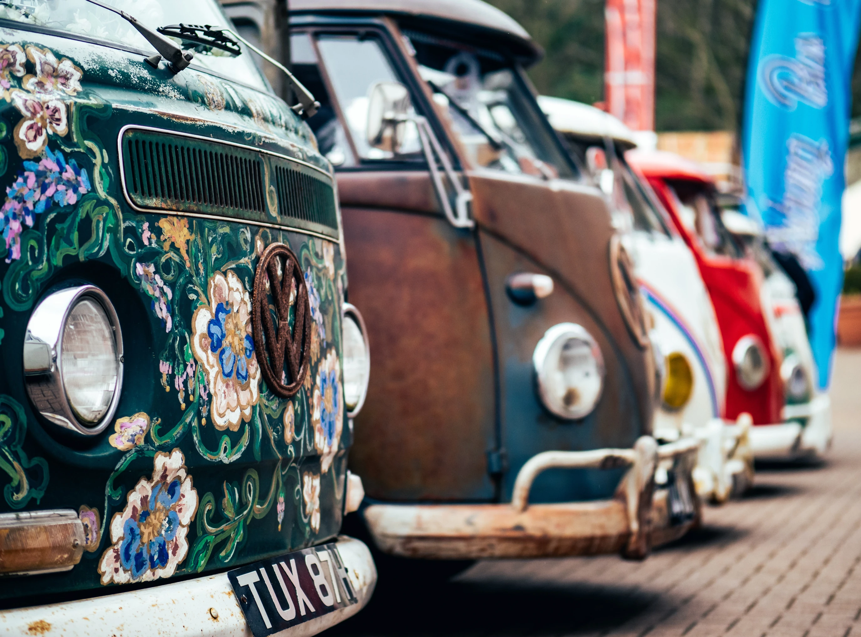 Colorful 1970's vans parked in a row.