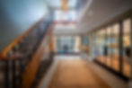 Hallway with modern glass doors and traditional staicase