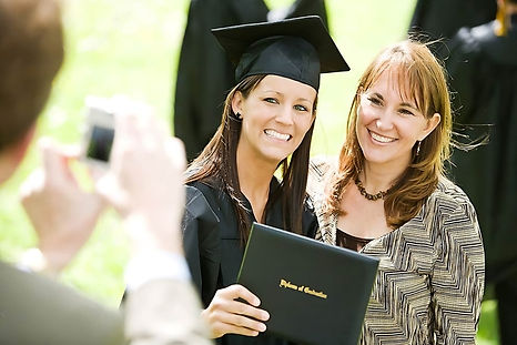 graduation-girl-poses-mom-picture-extensive-series-recent-student-graduates-outside-friend