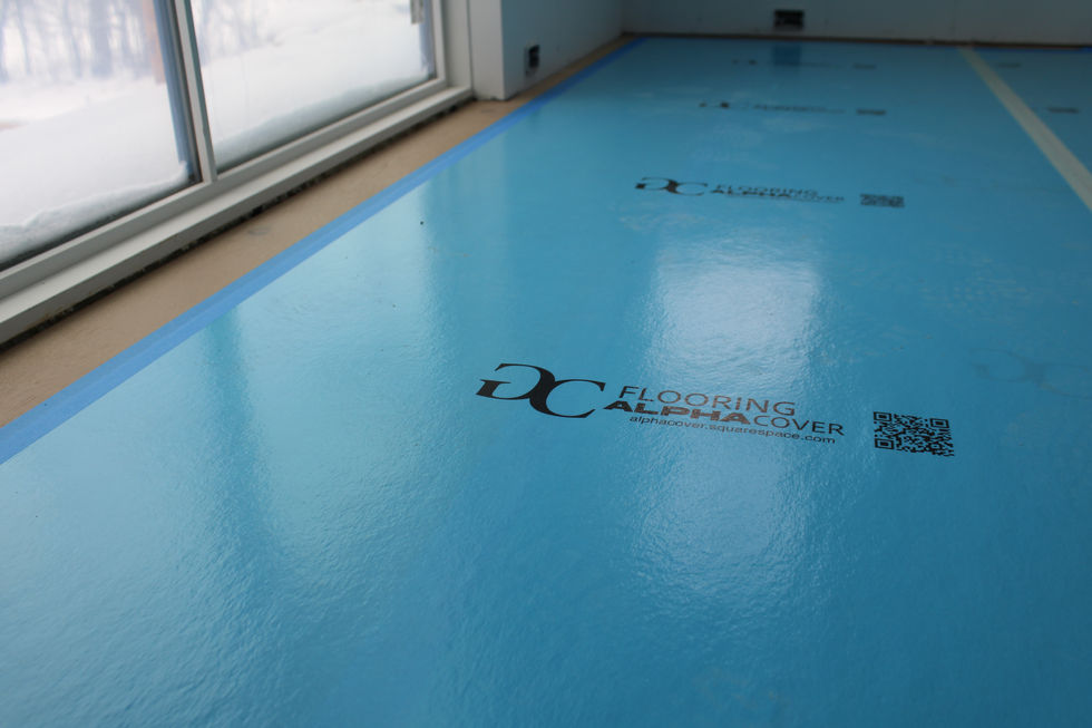 a blue floor with the words flooring alpha cover on it