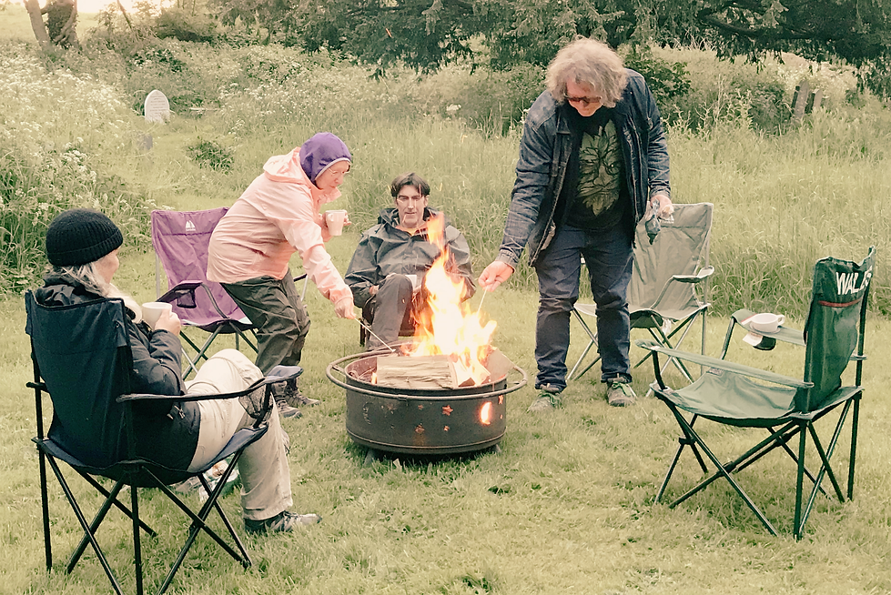 pilgrims toasting marshmallows around a campfire