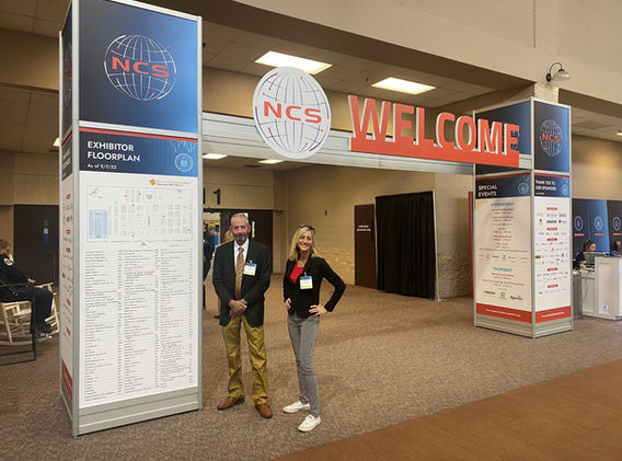 Patricia Giesler and Willis Arnold at Welcome Sign for 2022 National Cyber Summit.