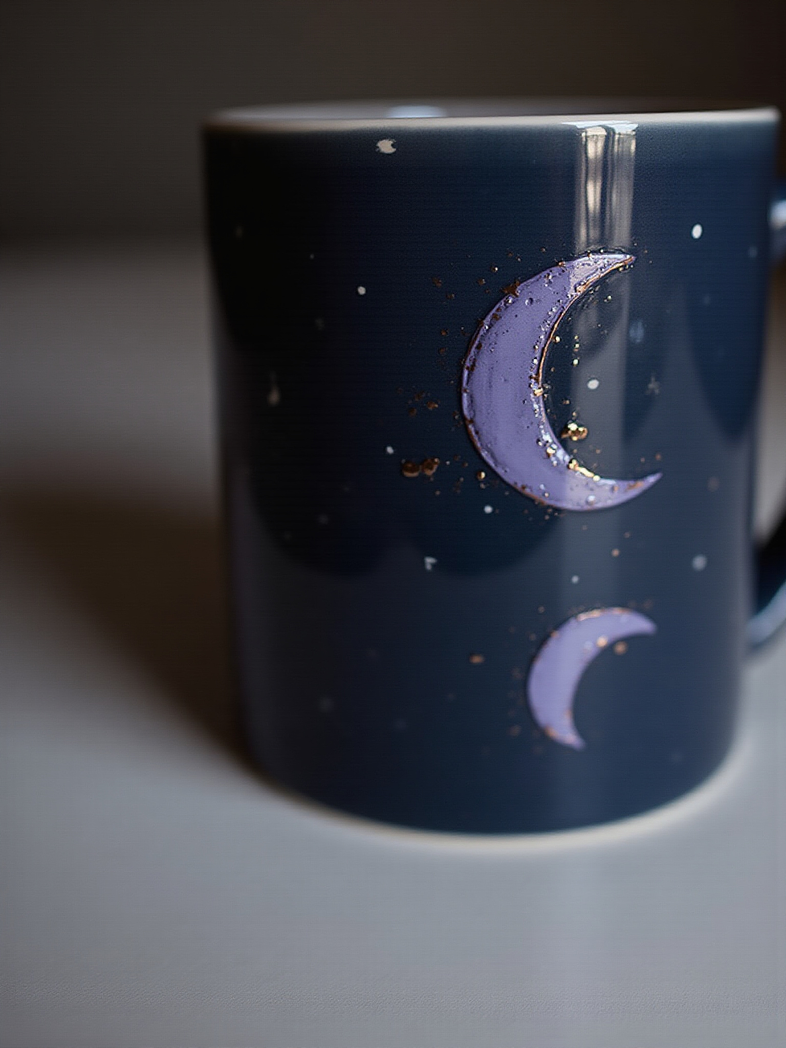 Dark blue mug adorned with purple crescent moons and sparkling stars design.